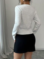Pullover Knit Sweater with a Bow Tie V-Neck And Split Design, Featuring Long Sleeves And a Short Floral-Patterned Style.
