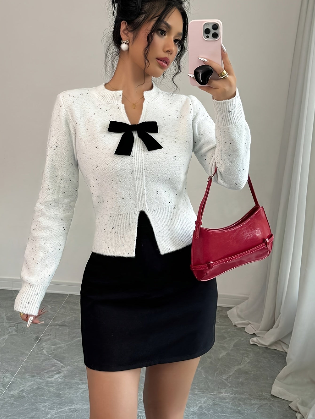 Pullover Knit Sweater with a Bow Tie V-Neck And Split Design, Featuring Long Sleeves And a Short Floral-Patterned Style.