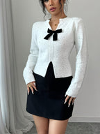 Pullover Knit Sweater with a Bow Tie V-Neck And Split Design, Featuring Long Sleeves And a Short Floral-Patterned Style.